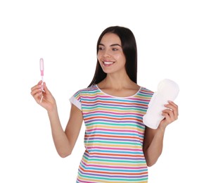 Young woman with menstrual pad and tampon on white background