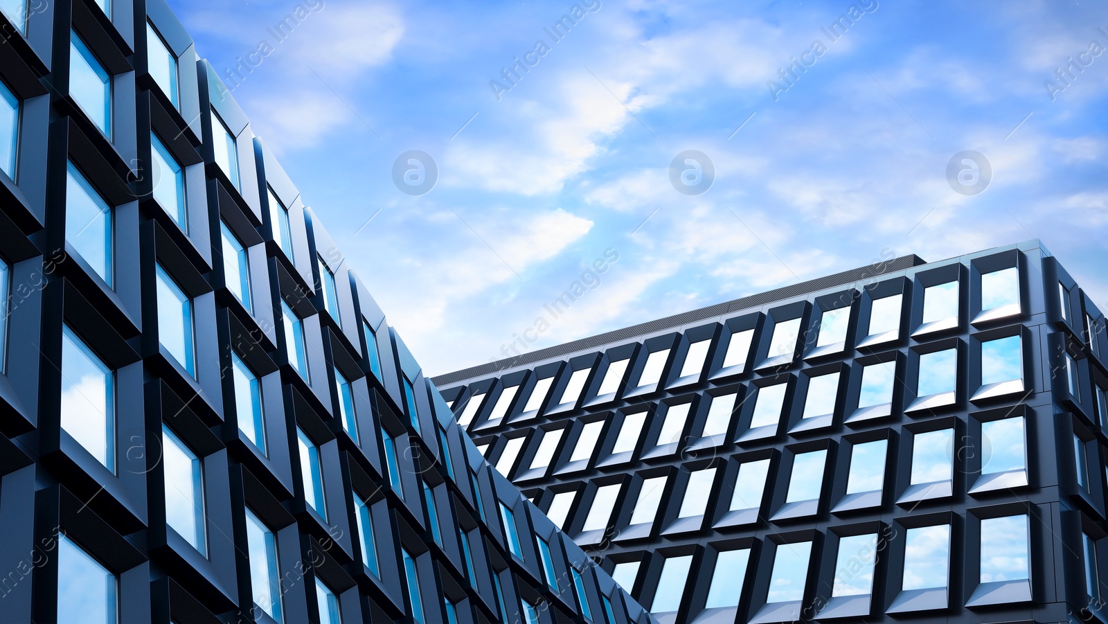 Image of Beautiful buildings under blue sky with clouds, low angle view