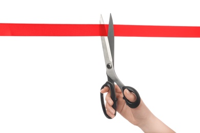 Photo of Woman cutting red ribbon with scissors on white background. Traditional ceremony