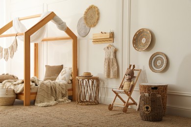 Photo of Stylish child room interior with house bed