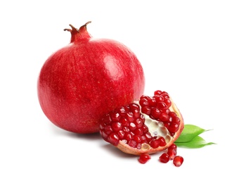 Photo of Ripe pomegranates with leaves on white background