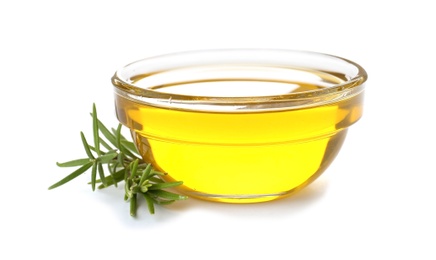 Photo of Bowl with rosemary oil on white background