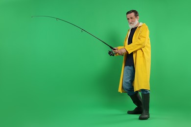 Photo of Fisherman with fishing rod on green background, space for text