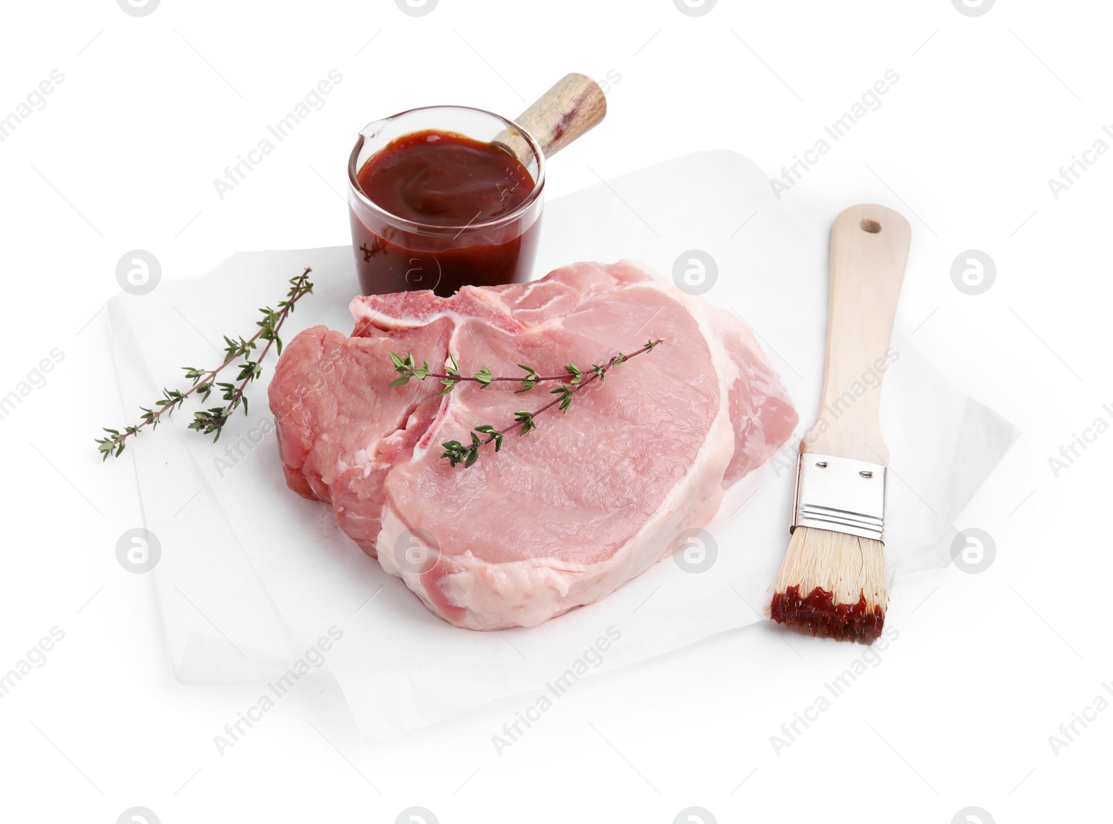 Photo of Raw meat, thyme, basting brush and marinade isolated on white