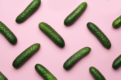 Photo of Flat lay composition with fresh ripe cucumbers on pink background