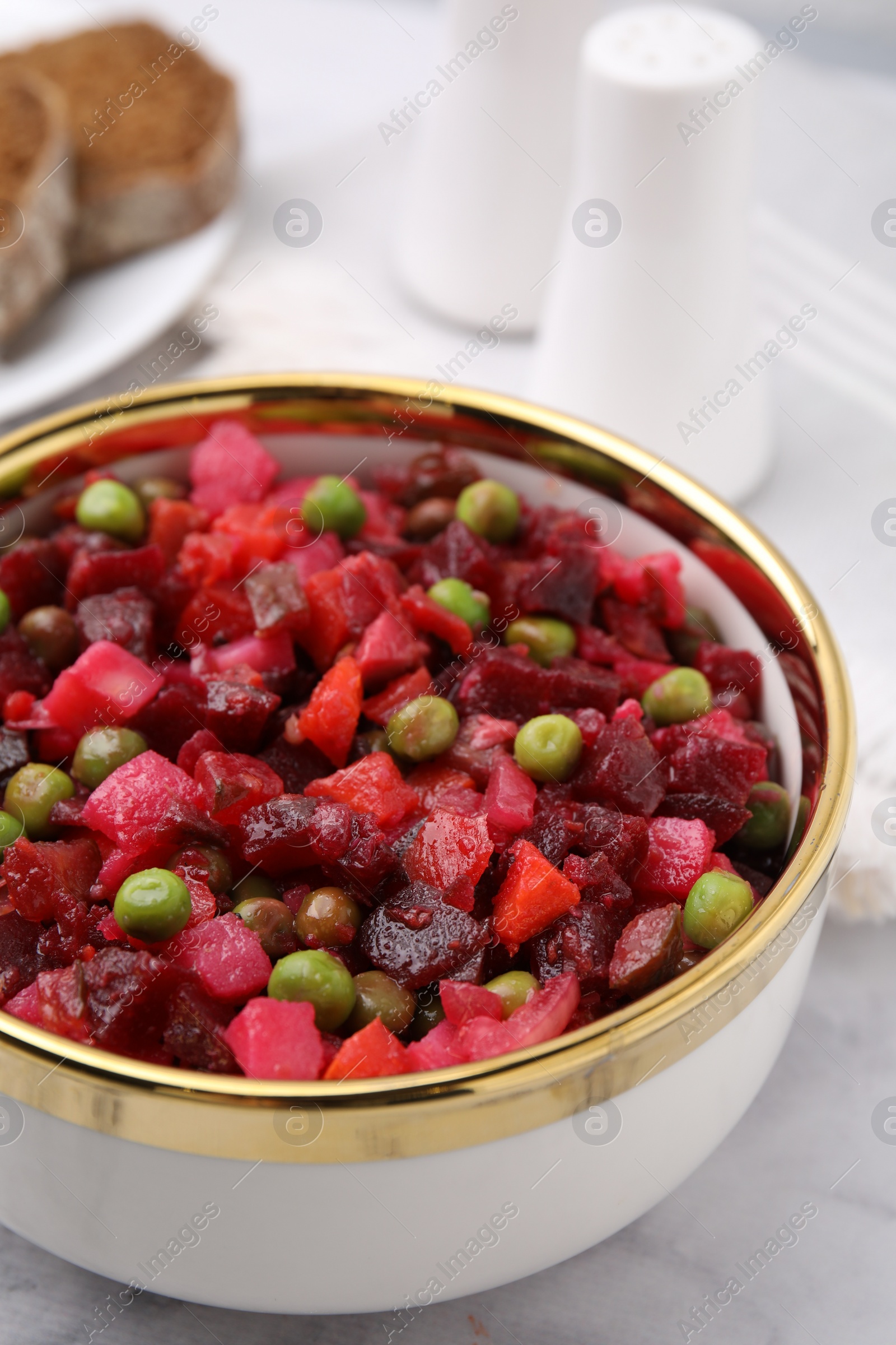 Photo of Delicious vinaigrette salad on white table, closeup