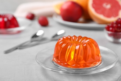 Photo of Delicious fresh orange jelly on grey table