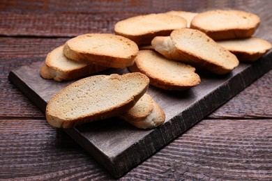 Photo of Tasty hard chuck crackers on wooden table