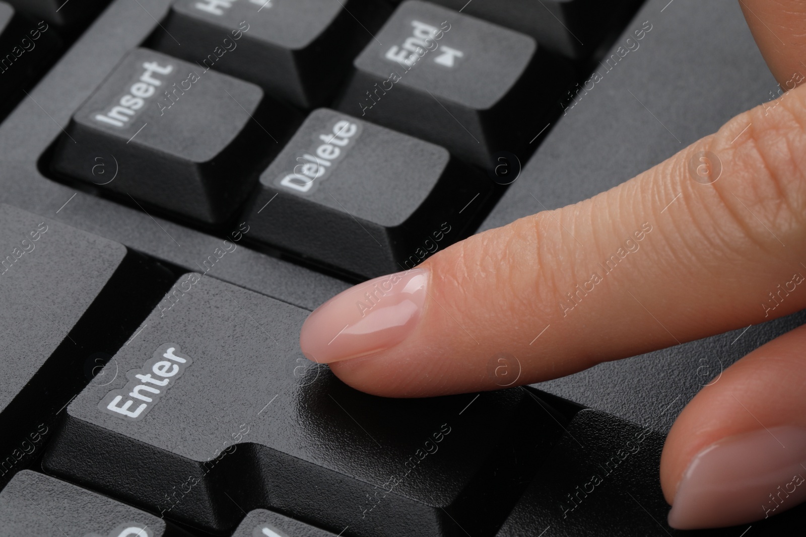 Photo of Woman pressing button on computer keyboard, closeup