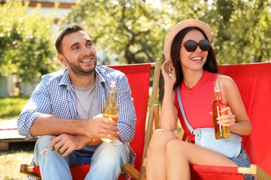 Young people enjoying picnic in park on summer day