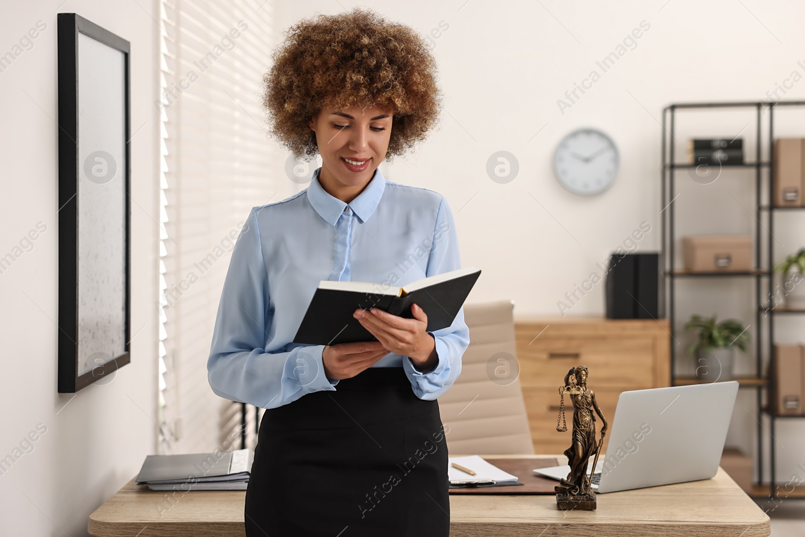 Photo of Portrait of happy notary with notebook in office