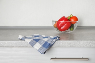 Photo of Fabric checkered towel on table in kitchen