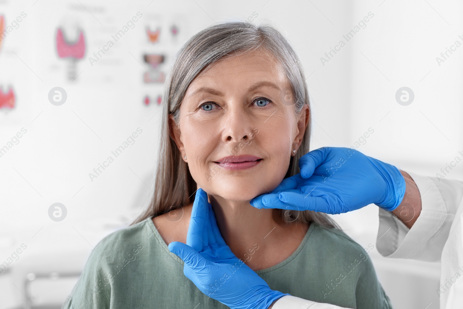 Photo of Endocrinologist examining thyroid gland of patient at hospital, closeup