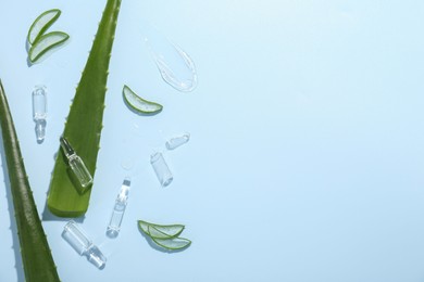 Photo of Flat lay composition with skincare ampoules and aloe leaves on light blue background. Space for text