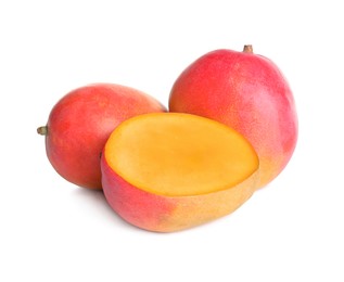 Photo of Delicious whole and cut mangoes on white background