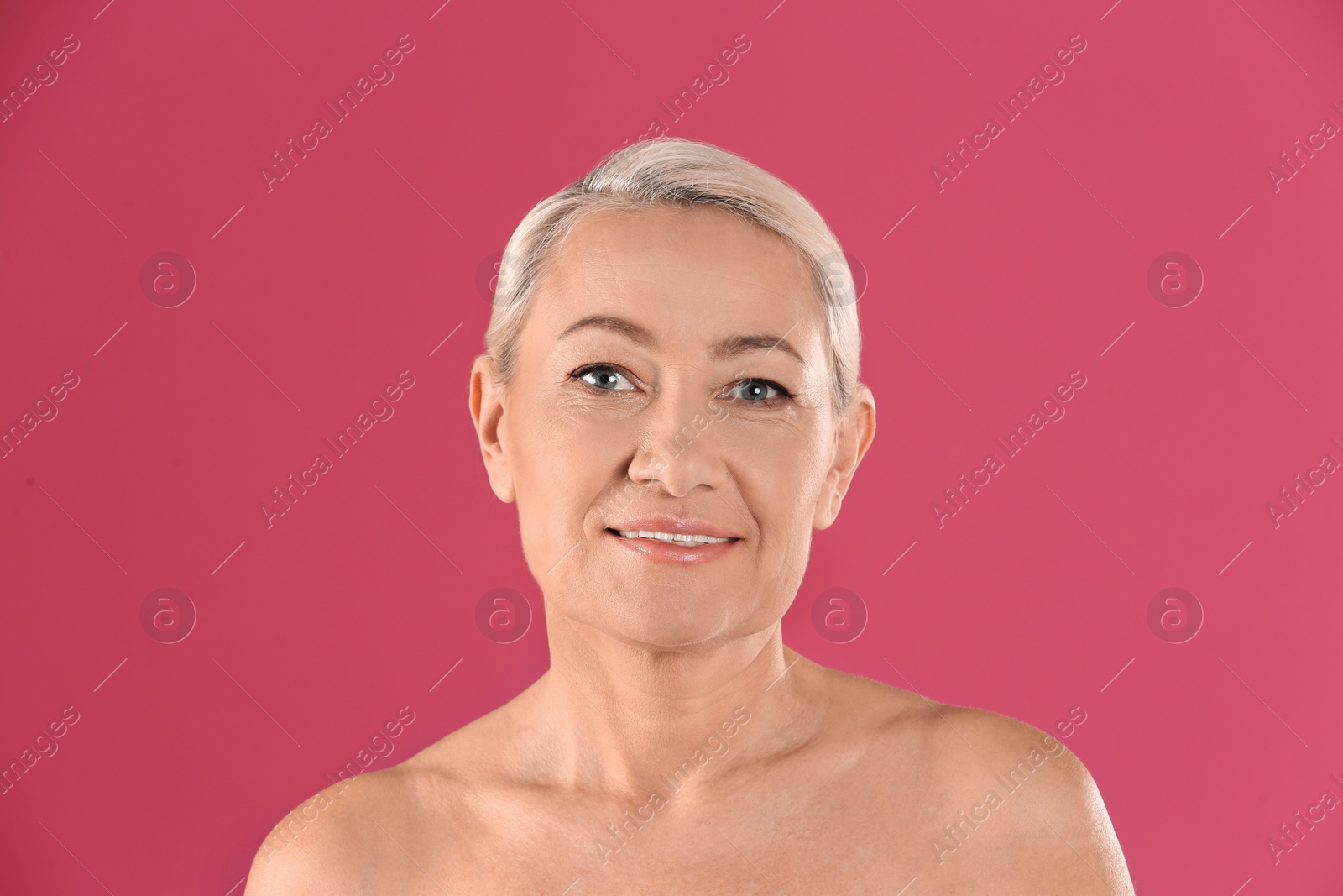 Photo of Portrait of beautiful mature woman on pink background