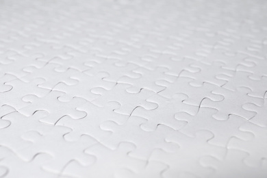 Photo of Blank white puzzle as background, closeup view