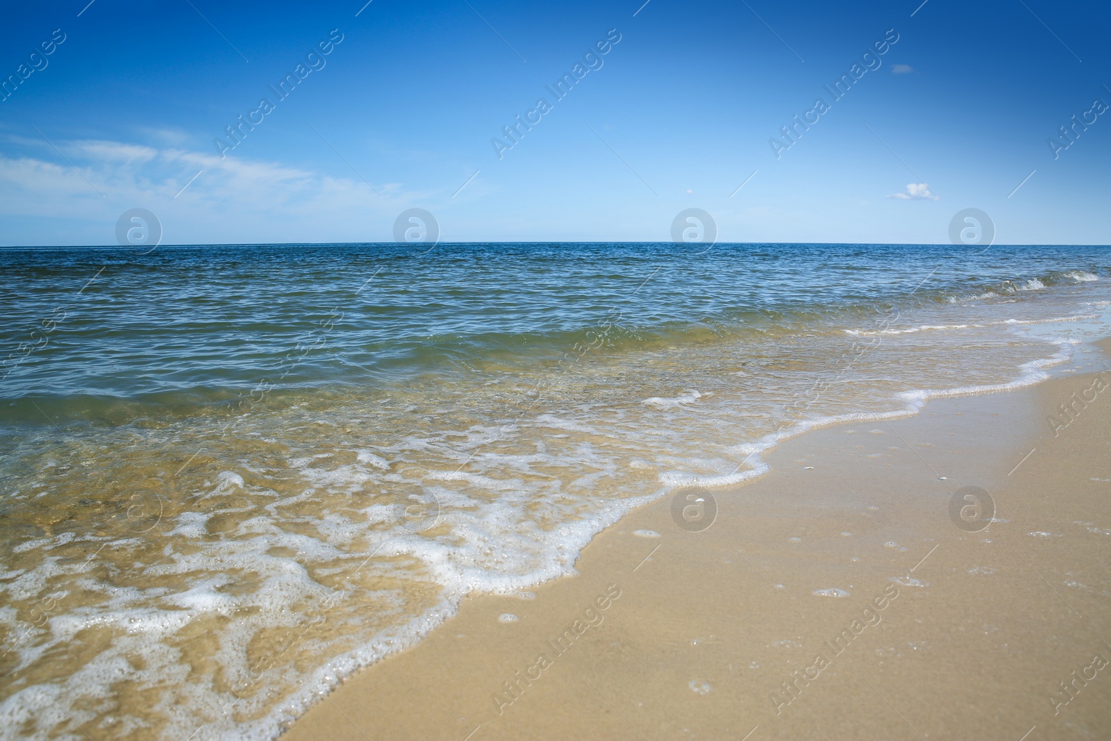 Photo of Beautiful view of sandy beach and sea on sunny day