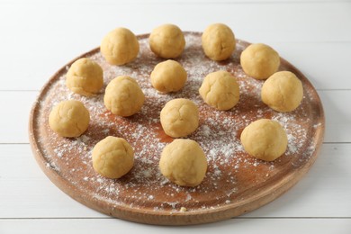 Photo of Shortcrust pastry. Raw dough balls on white wooden table