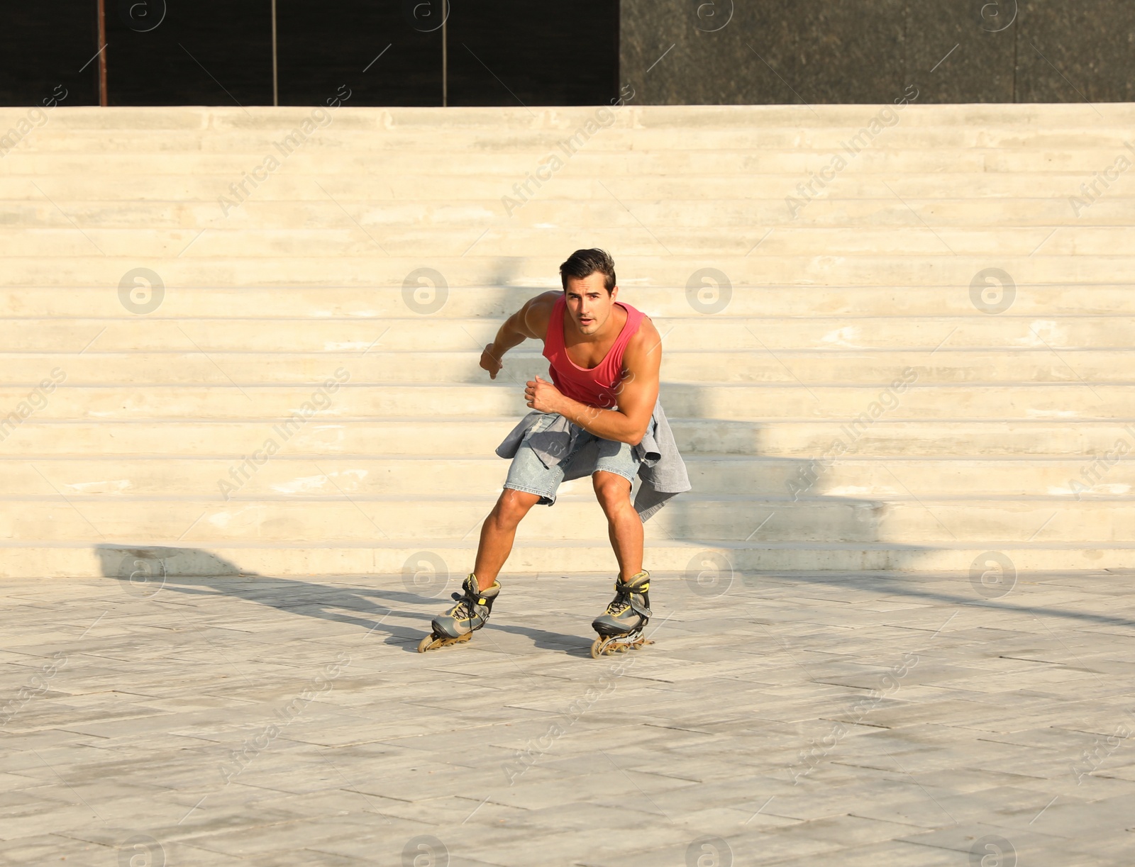 Photo of Handsome young man roller skating on city street