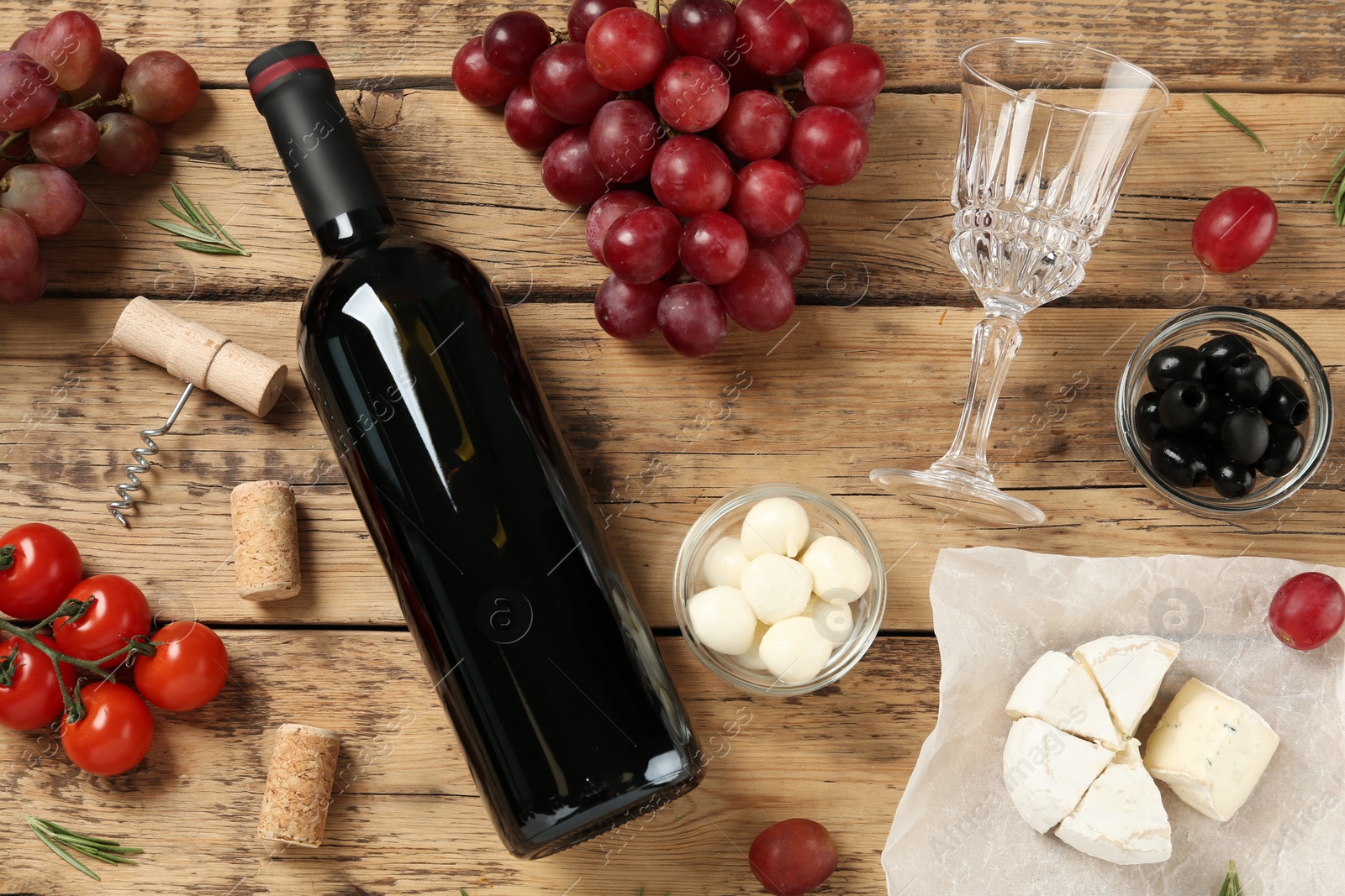 Photo of Flat lay composition with red wine and snacks on wooden table