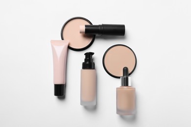 Photo of Different types of skin foundation on white background, flat lay. Makeup product