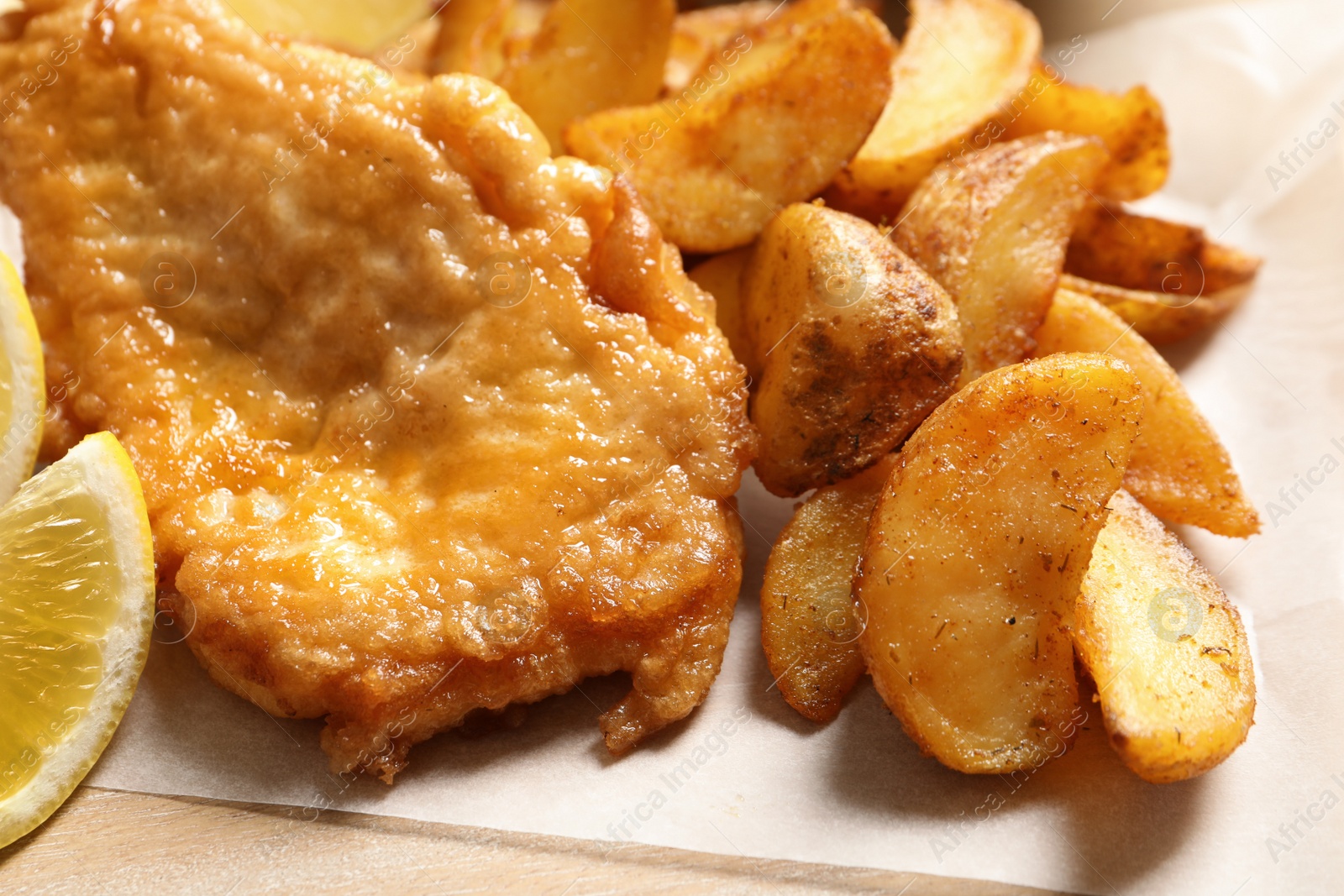 Photo of British traditional fish and potato chips, closeup