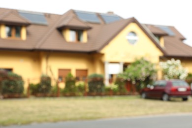Photo of Blurred view of beautiful house with car parked nearby
