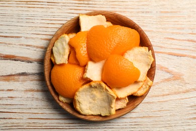 Photo of Orange peels preparing for drying on wooden table, top view