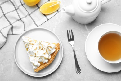 Photo of Delicious lemon meringue pie served on light grey table, flat lay