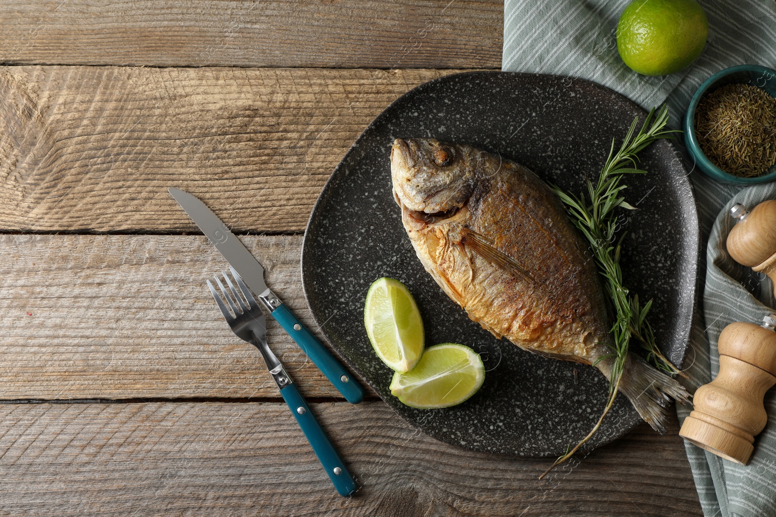 Photo of Delicious dorado fish served on wooden table, flat lay. Space for text