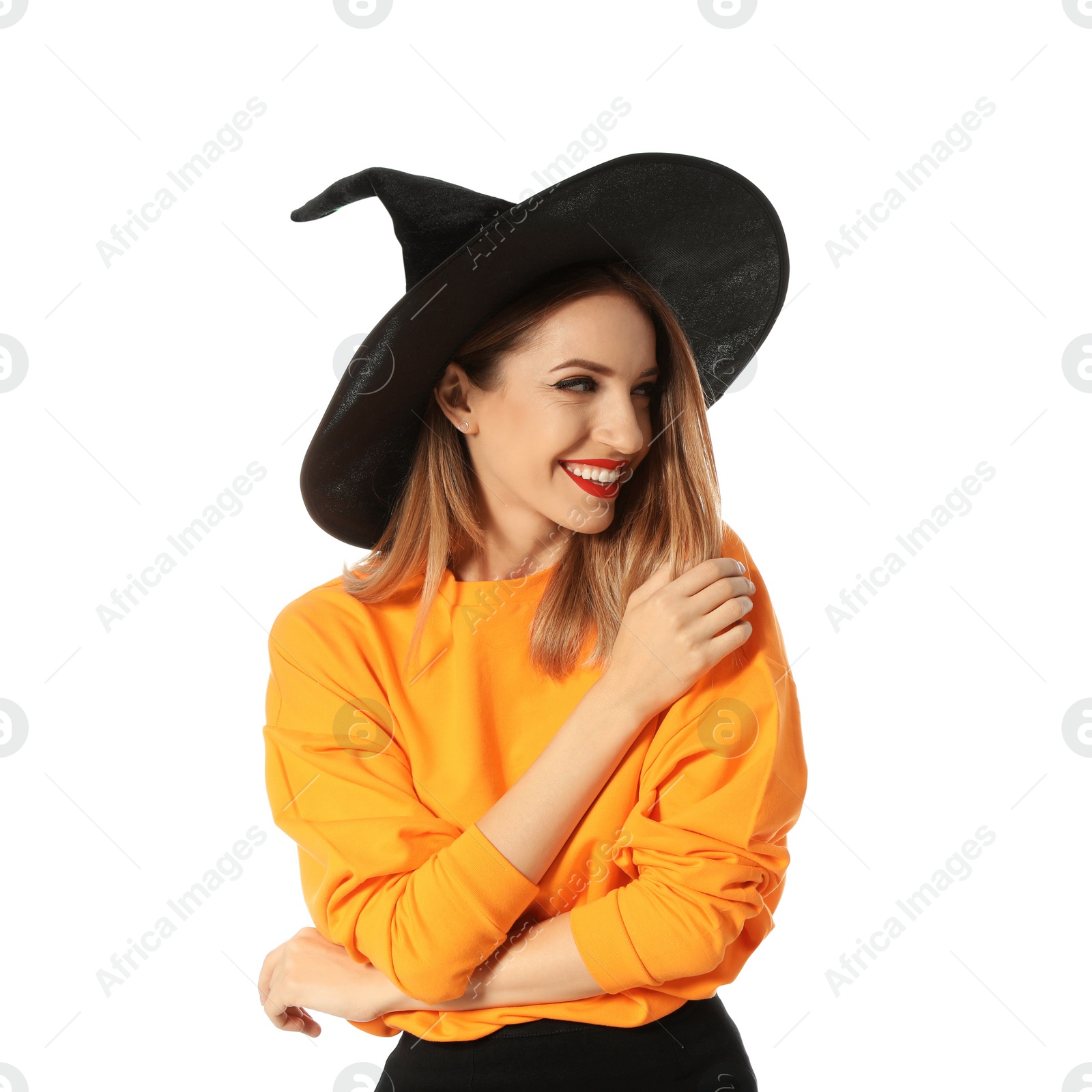 Photo of Beautiful young woman wearing witch costume for Halloween party on white background