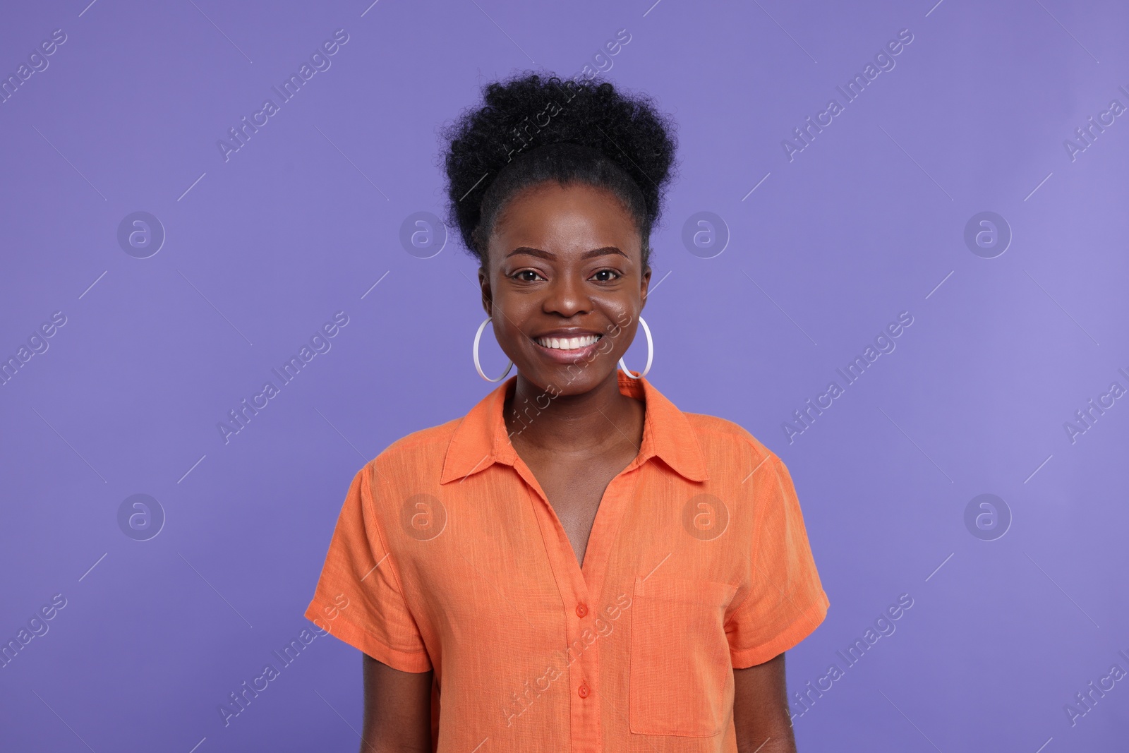 Photo of Portrait of happy young woman on purple background