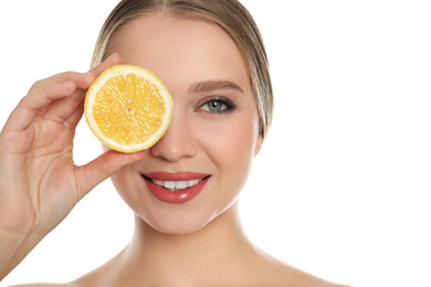 Young woman with cut lemon on white background. Vitamin rich food