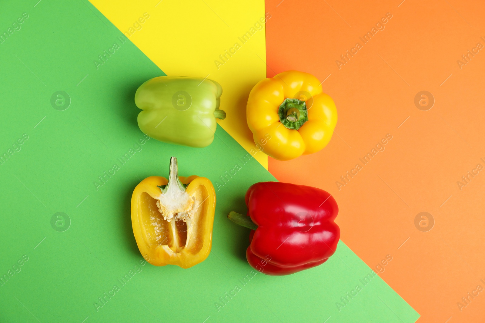 Photo of Flat lay composition with ripe bell peppers on color background