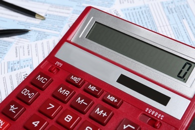 Photo of Calculator and stationery on documents, closeup. Tax accounting