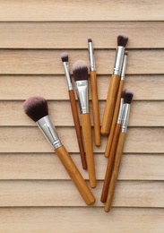 Makeup brushes on wooden background