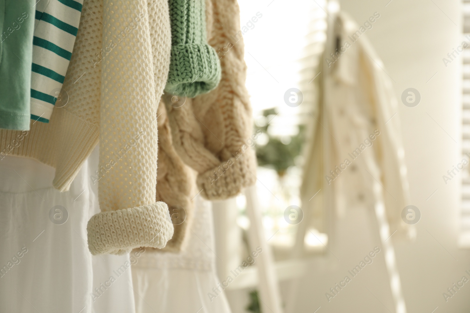 Photo of Rack with stylish women's clothes indoors, space for text. Interior design