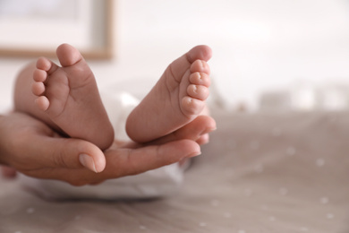 Photo of Mother and her little baby on bed, closeup