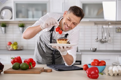 Photo of Professional chef presenting delicious dish in kitchen