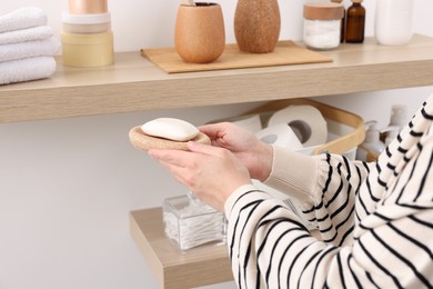 Photo of Bath accessories. Woman with soap indoors, closeup and space for text