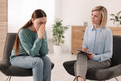 Photo of Professional psychotherapist working with patient in office