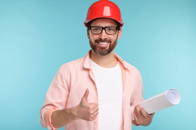 Photo of Architect in hard hat with draft showing thumbs up on light blue background