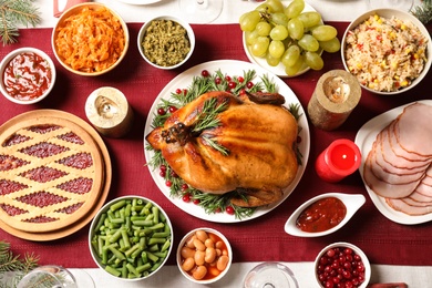 Photo of Traditional festive dinner with delicious roasted turkey served on table, flat lay