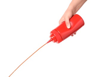 Photo of Woman pouring tasty ketchup from bottle on white background, closeup