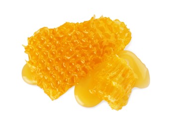 Photo of Pieces of natural honeycomb with tasty honey isolated on white, top view