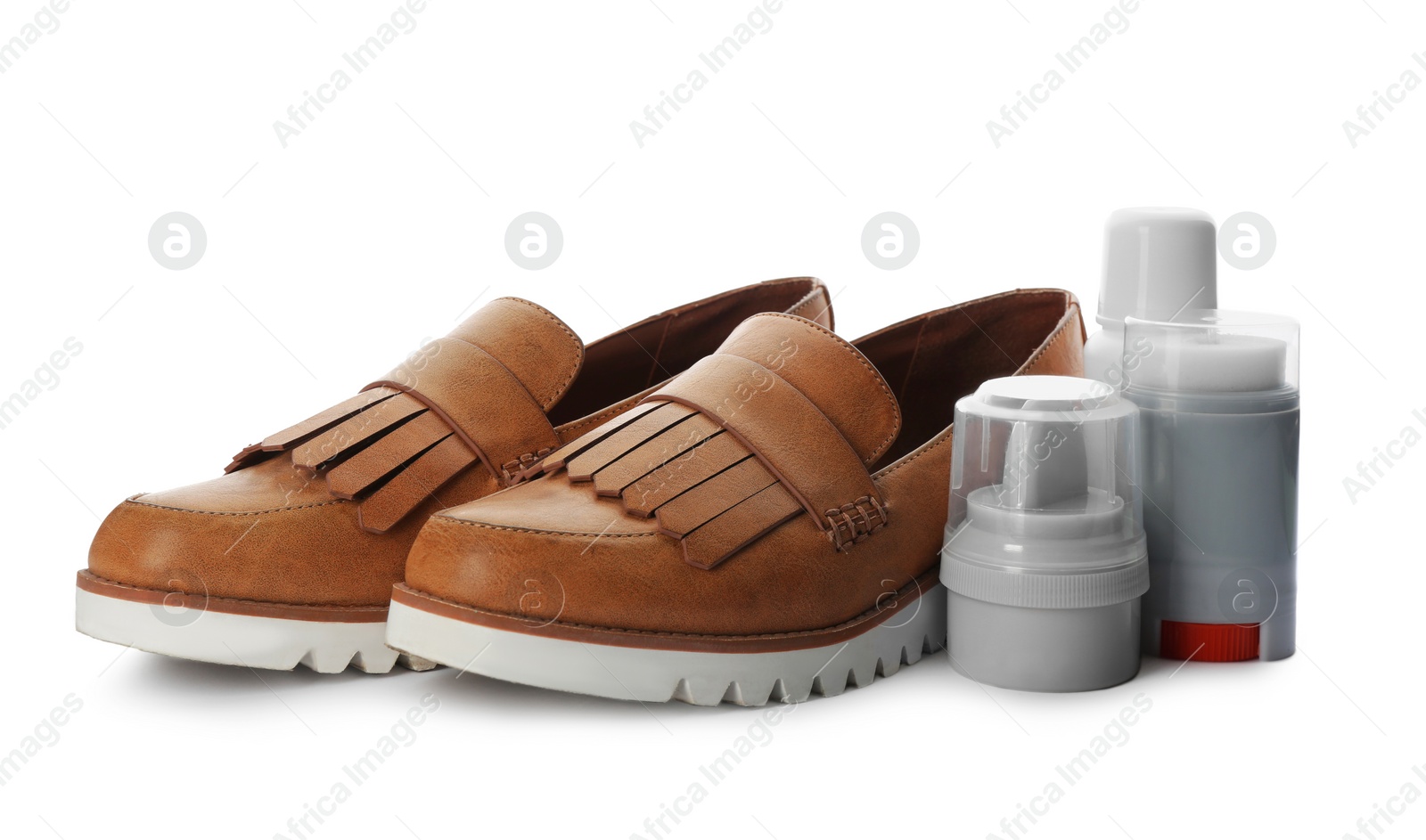 Stylish footwear and shoe care products on white background Photo of Stylish footwear and shoe care products on white background