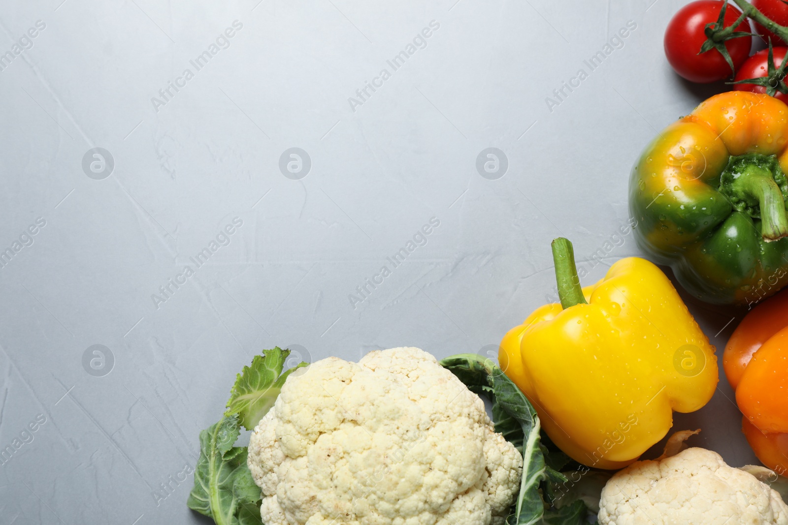 Photo of Fresh ripe vegetables on light grey table, flat lay. Space for text