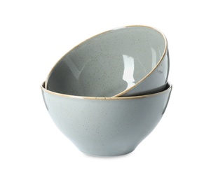 Photo of New grey ceramic bowls on white background