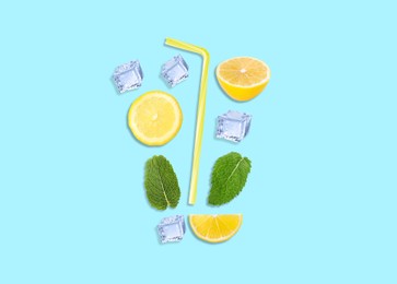Image of Creative lemonade layout with lemon slices, mint, ice cubes and straw on turquoise background, top view